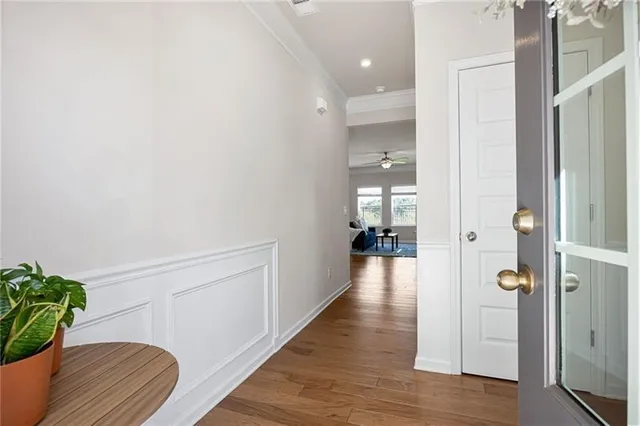 a view of a hallway with wooden floor and staircase