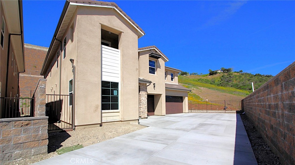 5887 Sunrise Rdg Lane Lake Forest, CA 92679 - Photo 2 of 5 a front view of a house with a yard