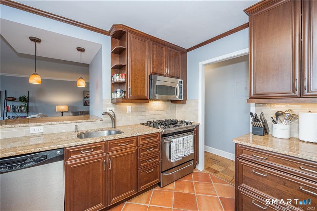50 Glenbrook Road, Unit 6E Stamford, CT 06902 - Photo 11 of 18 a kitchen with stainless steel appliances granite countertop a sink stove and cabinets