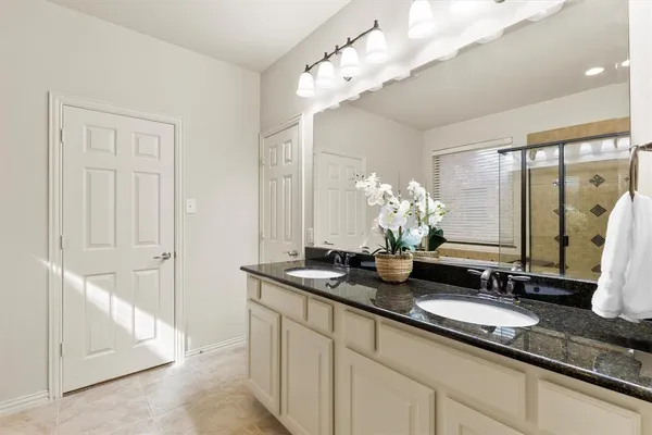 a bathroom with a double vanity sink and a mirror