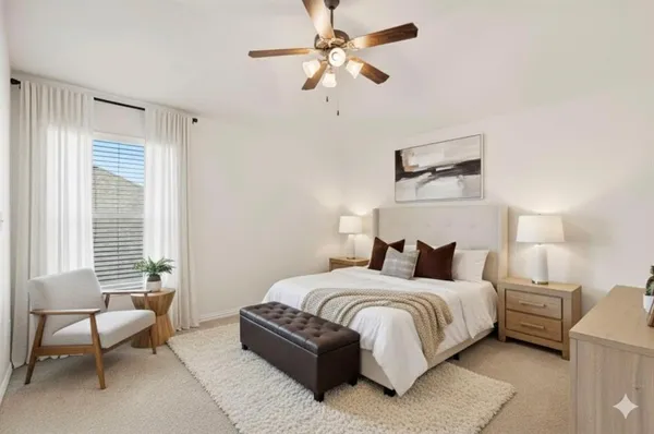 an empty room with a window and a ceiling fan