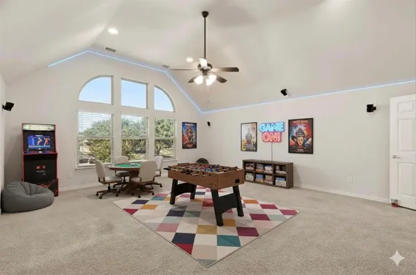 a living room with furniture chess table and large window