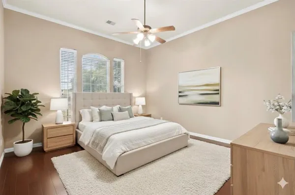 a bedroom with a large bed and a potted plant