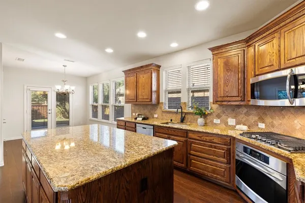 a kitchen with granite countertop lots of counter top space and stainless steel appliances