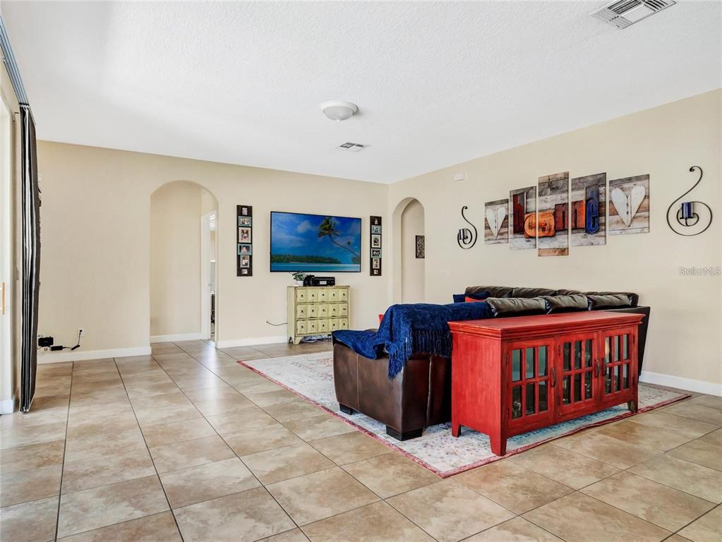 10023 Ians Ridge Road Orlando, FL 32832 - Photo 12 of 60 a living room with furniture and a flat screen tv