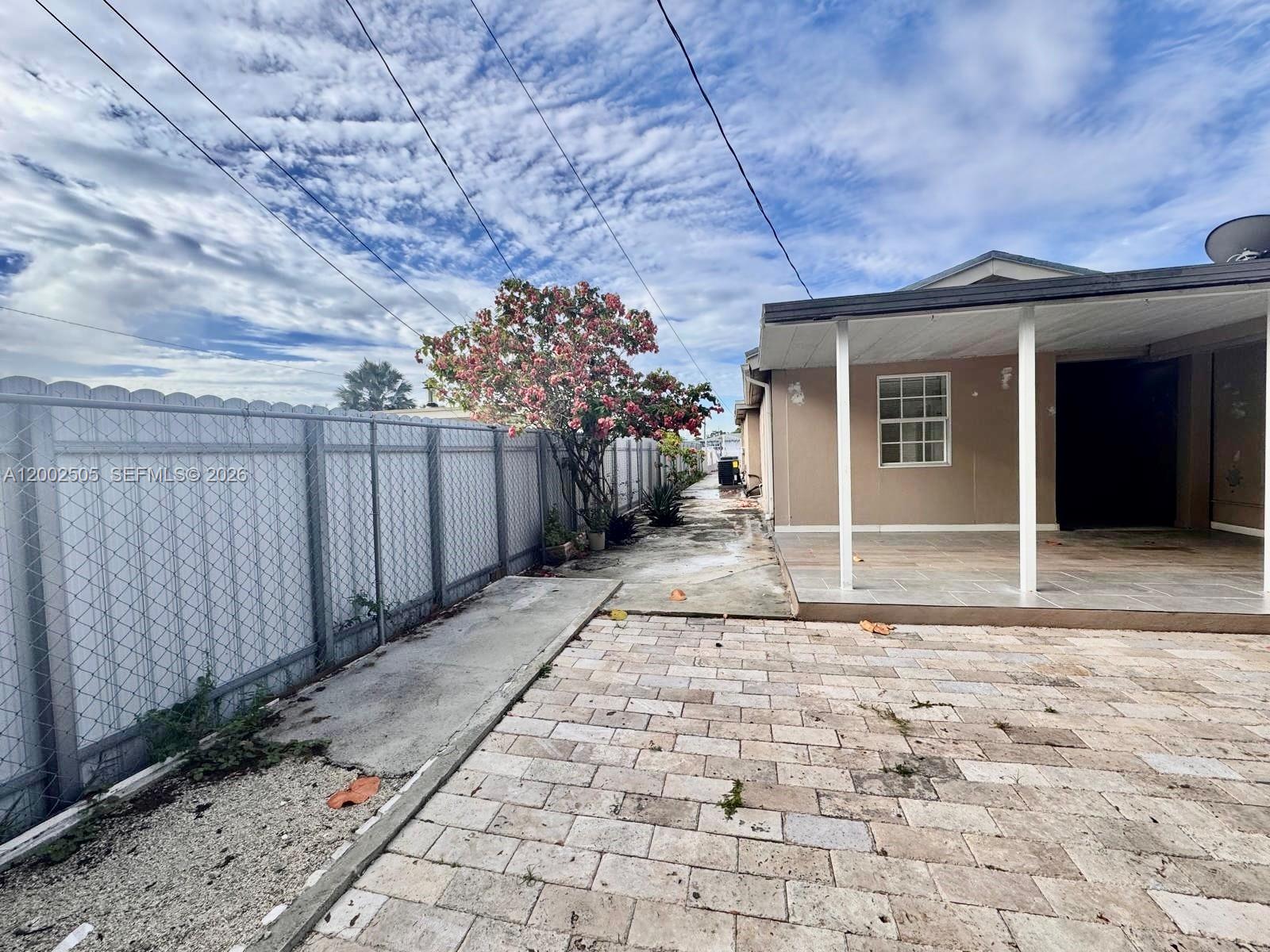 541 East 38th Street Hialeah, FL 33013 - Photo 12 of 14 a view of a pathway along the house