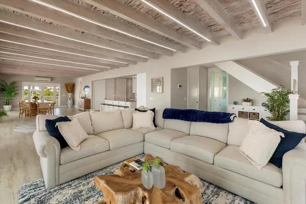 a living room with furniture and a large mirror
