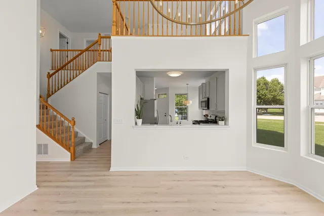 a view of entryway and hall with wooden floor