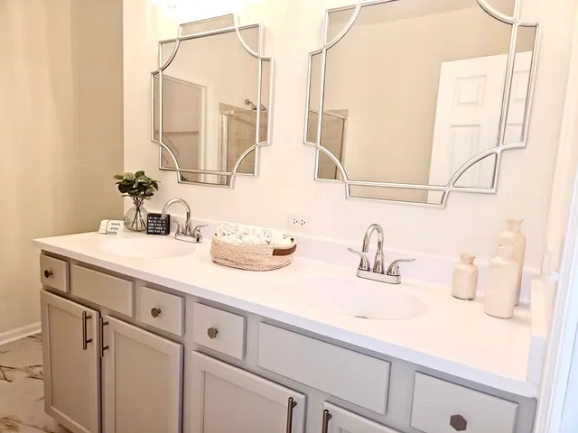 a bathroom with a double vanity sink and mirror