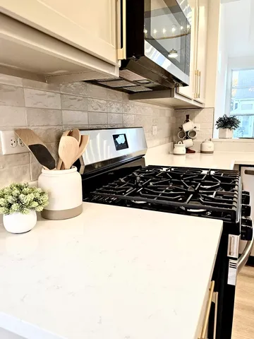 a kitchen with a stove a sink and a microwave
