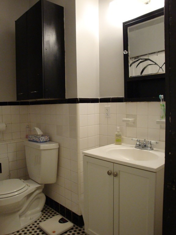 21 Beacon Street, Unit 6D Boston, MA 02108 - Photo 10 of 13 a bathroom with a toilet a sink and mirror