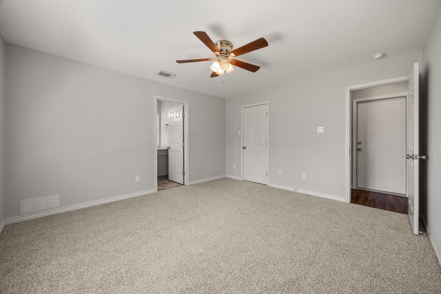 521 Britni Loop Kyle, TX 78640 - Photo 11 of 23 a view of an empty room with a ceiling fan