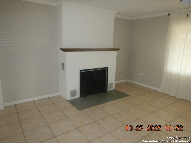 15397 Cassiano Road Elmendorf, TX 78112 - Photo 21 of 29 a view of an empty room with window and fire place