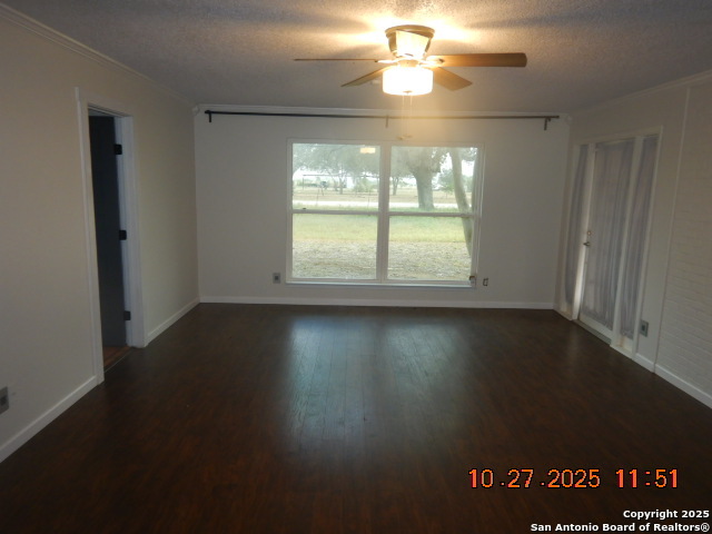 15397 Cassiano Road Elmendorf, TX 78112 - Photo 22 of 29 an empty room with wooden floor and windows