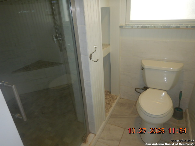 15397 Cassiano Road Elmendorf, TX 78112 - Photo 27 of 29 a bathroom with a toilet and a shower