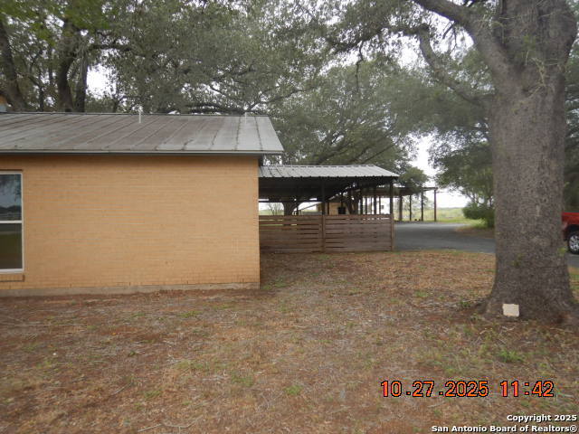 15397 Cassiano Road Elmendorf, TX 78112 - Photo 3 of 29 a backyard of a house with table and chairs