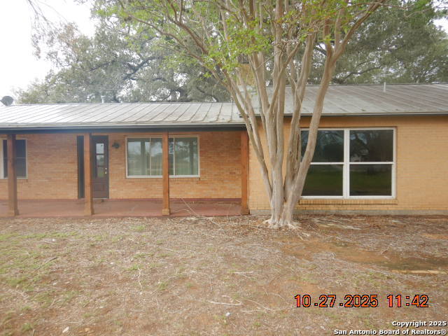 15397 Cassiano Road Elmendorf, TX 78112 - Photo 4 of 29 a house with trees in front of it