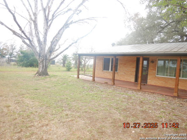 15397 Cassiano Road Elmendorf, TX 78112 - Photo 5 of 29 a view of a house with backyard and tree