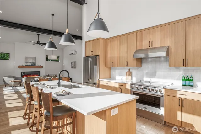 a open kitchen with stainless steel appliances granite countertop a sink stove and refrigerator