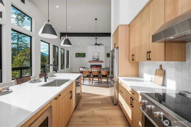 a kitchen with a sink a mirror and cabinets