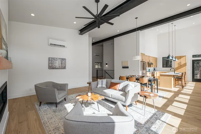 a view of a dining room with furniture large windows and wooden floor