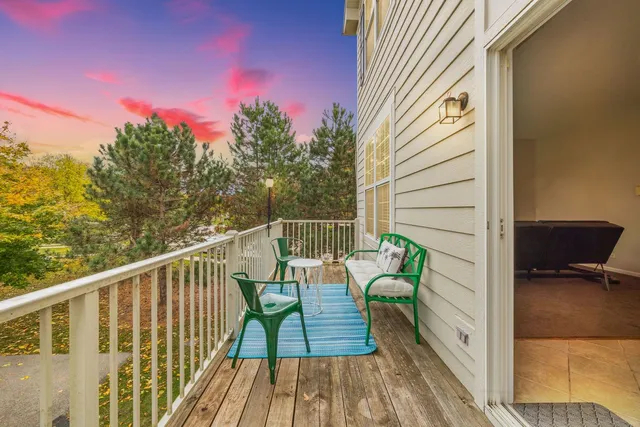 a view of balcony with wooden floor and seating space