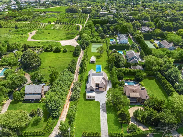 an aerial view of residential houses with outdoor space and street view