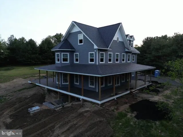 a view of a house with a wooden deck and a yard