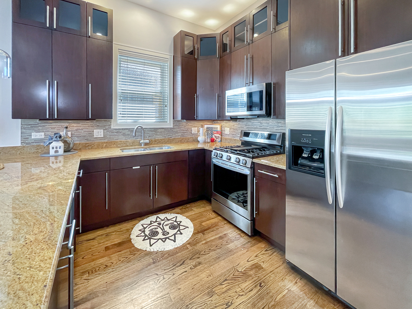 2207 West Roscoe Street, Unit 3E Chicago, IL 60618 - Photo 12 of 25 a kitchen with stainless steel appliances granite countertop a sink stove and refrigerator