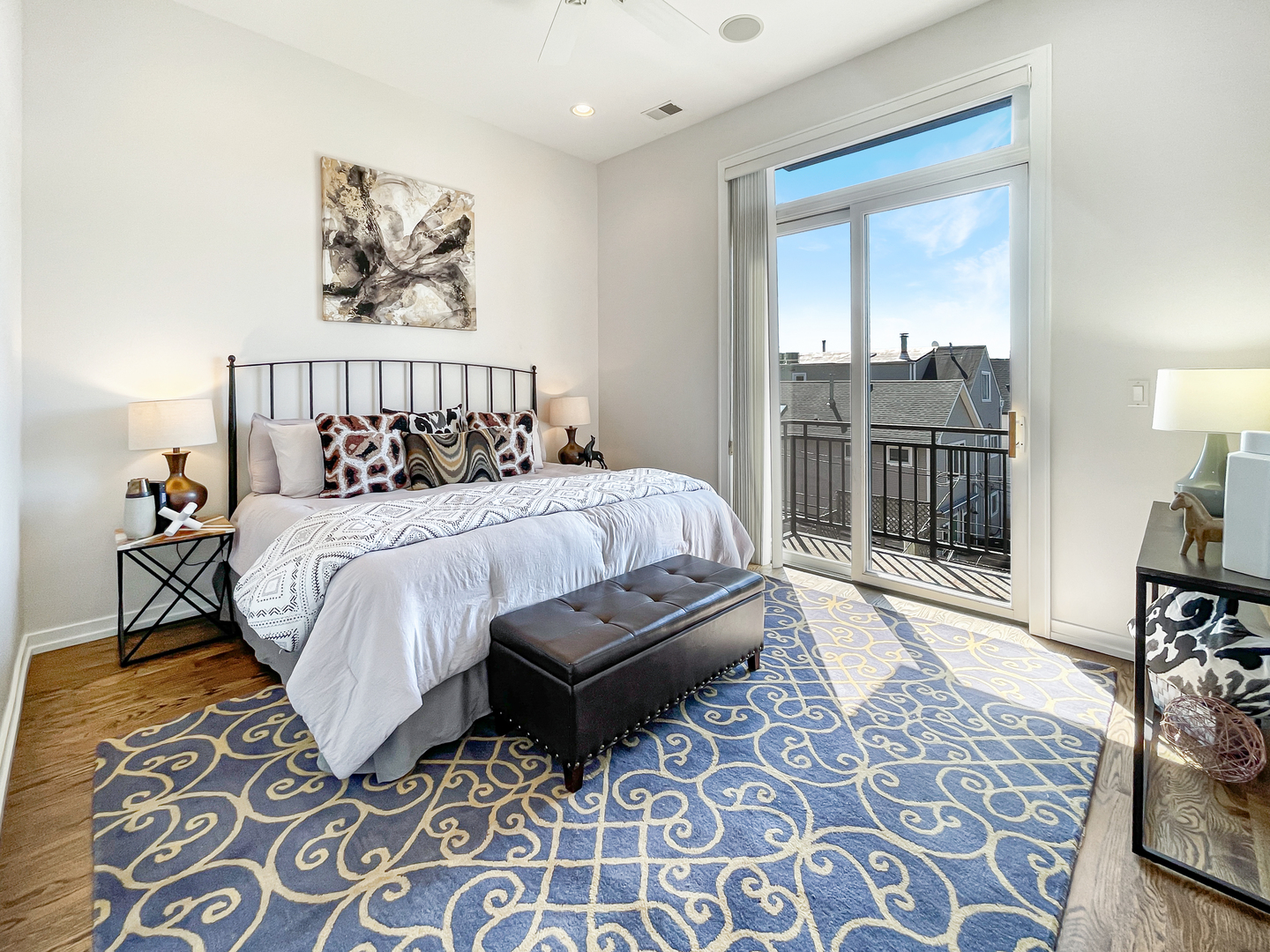 2207 West Roscoe Street, Unit 3E Chicago, IL 60618 - Photo 13 of 25 a bedroom with a bed wooden floor and a desk