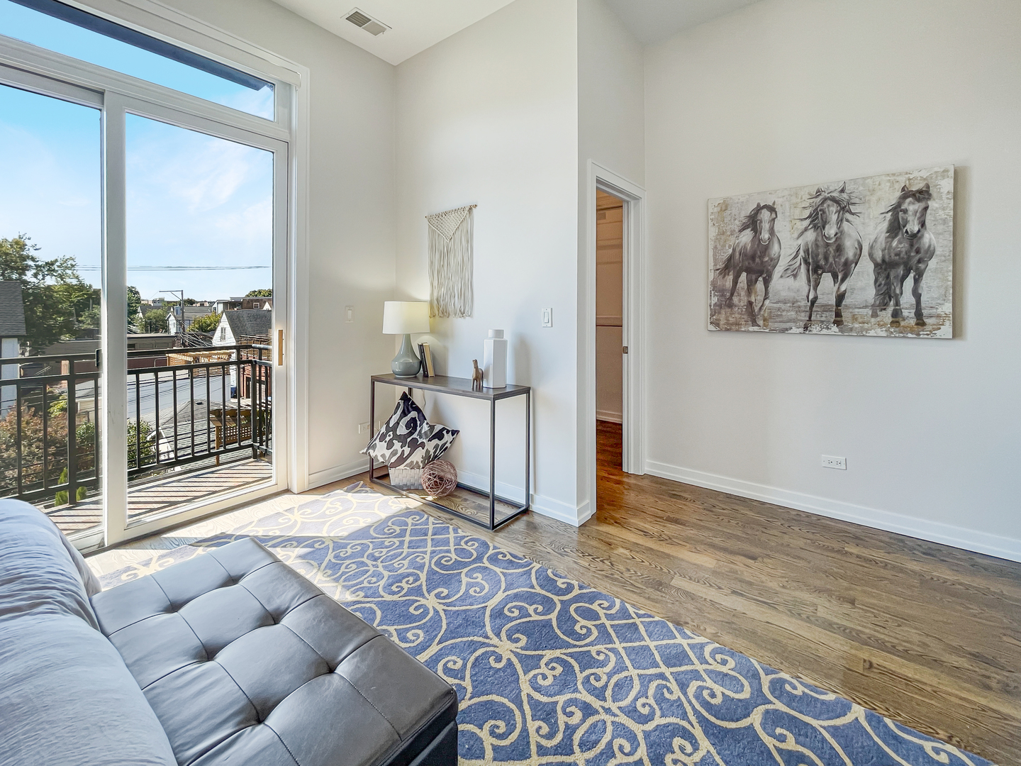 2207 West Roscoe Street, Unit 3E Chicago, IL 60618 - Photo 14 of 25 a living room with furniture and a rug