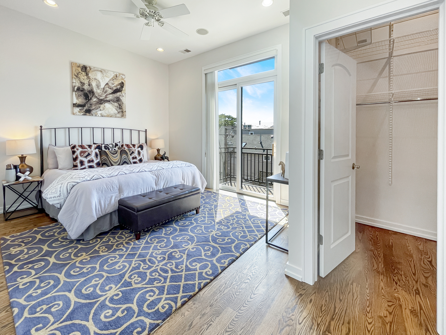 2207 West Roscoe Street, Unit 3E Chicago, IL 60618 - Photo 16 of 25 a bedroom with a large bed and a chandelier
