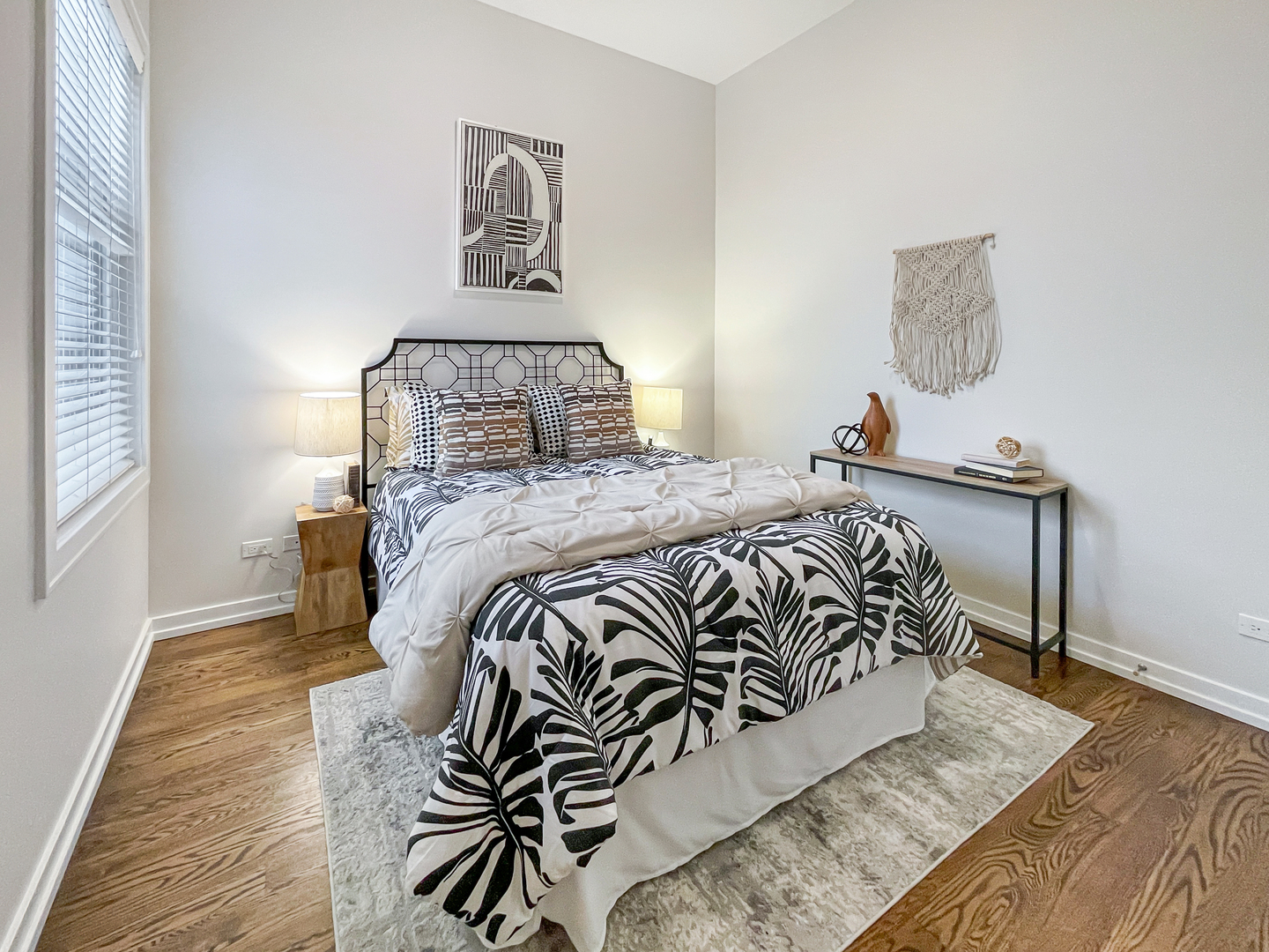 2207 West Roscoe Street, Unit 3E Chicago, IL 60618 - Photo 18 of 25 a bedroom with a bed and wooden floor
