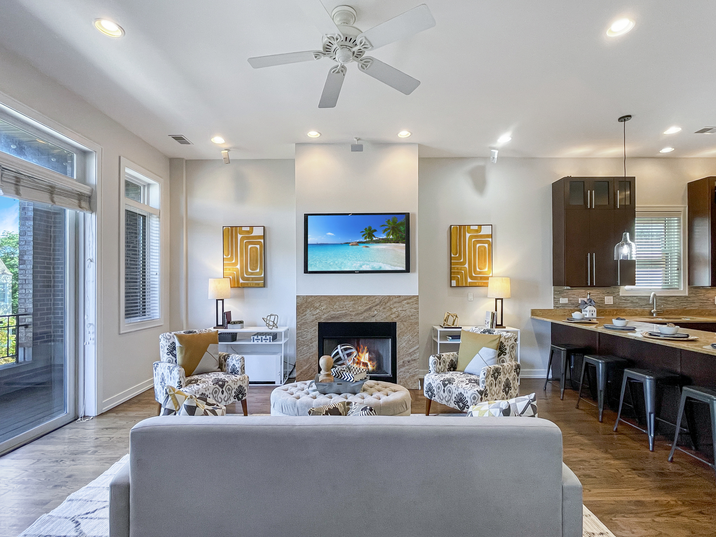 2207 West Roscoe Street, Unit 3E Chicago, IL 60618 - Photo 6 of 25 a living room with furniture a fireplace and a chandelier