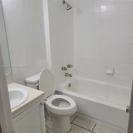 a bathroom with a bathtub and toilet