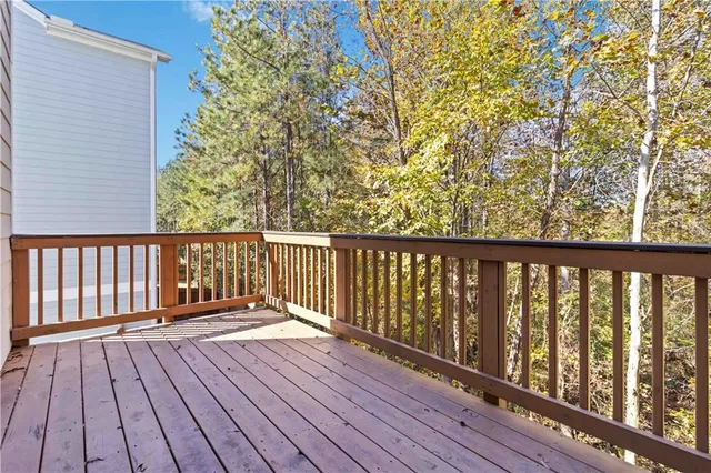 a balcony with wooden floor and fence