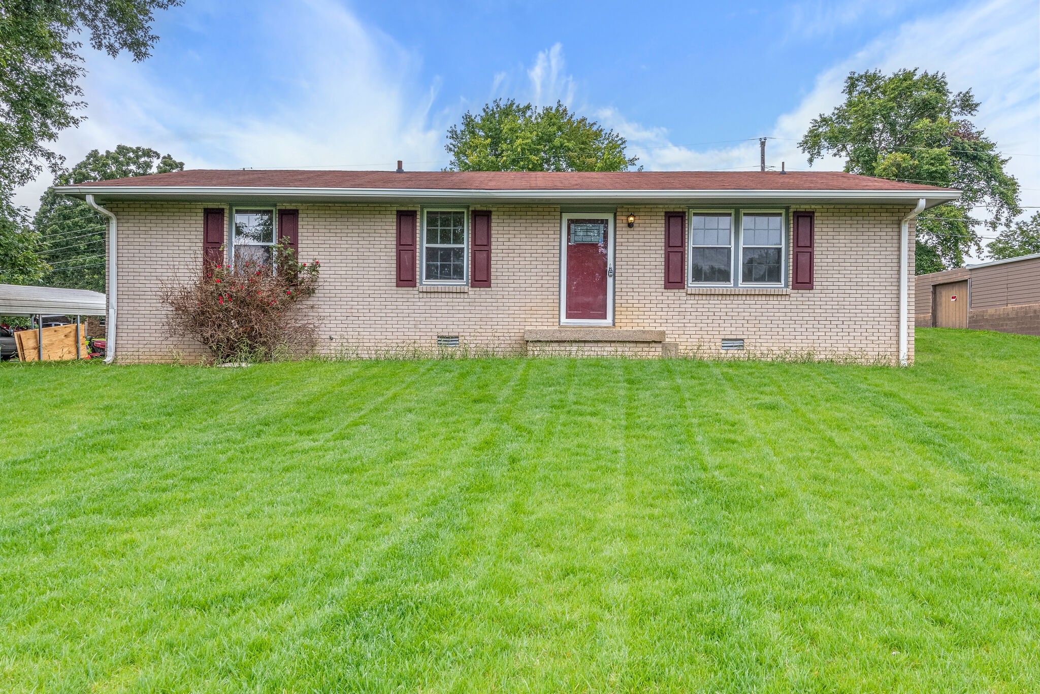 a front view of house with yard and green space