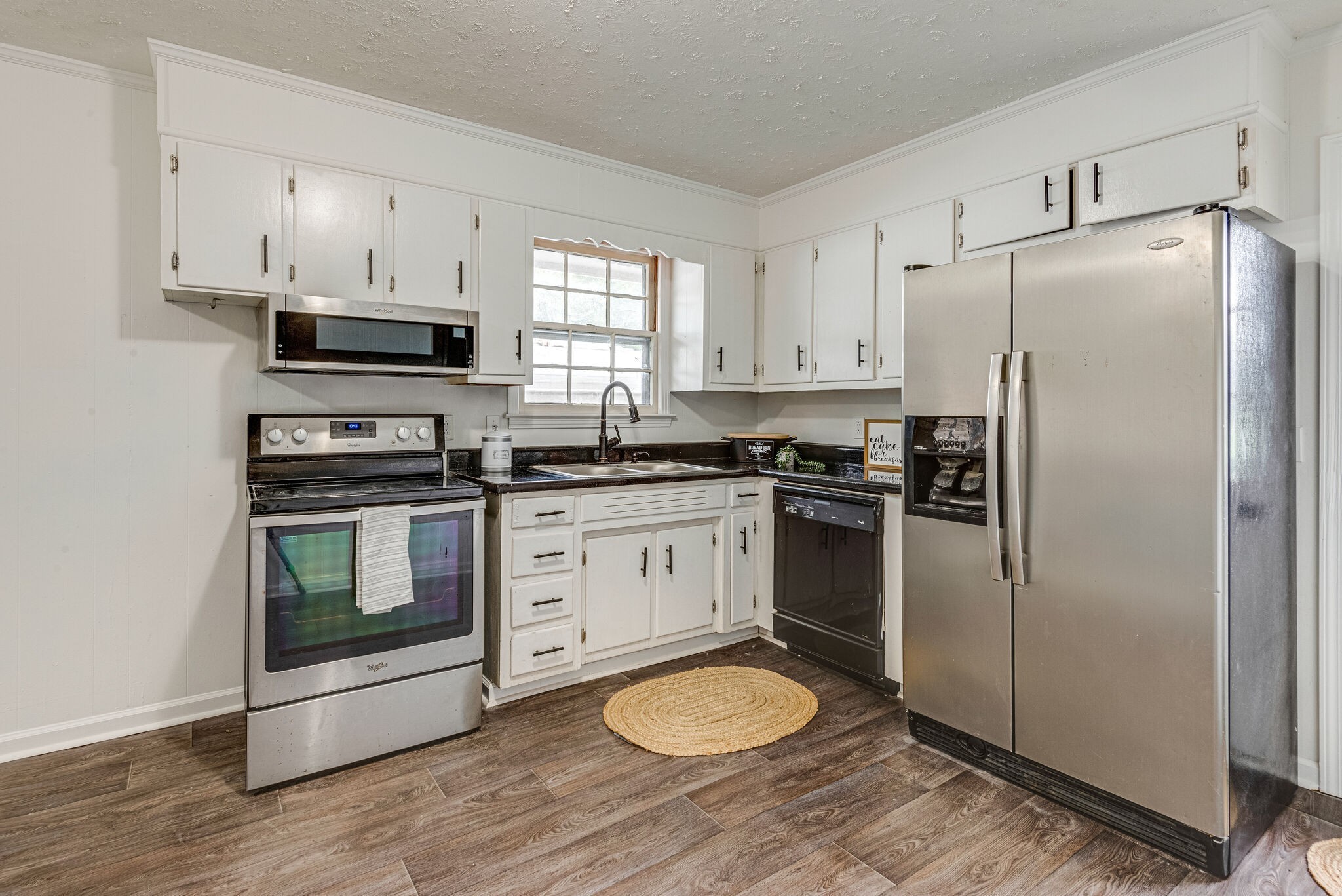 108 Chestnut Drive Dickson, TN 37055 - Photo 12 of 25 a kitchen with a refrigerator stove and white cabinets