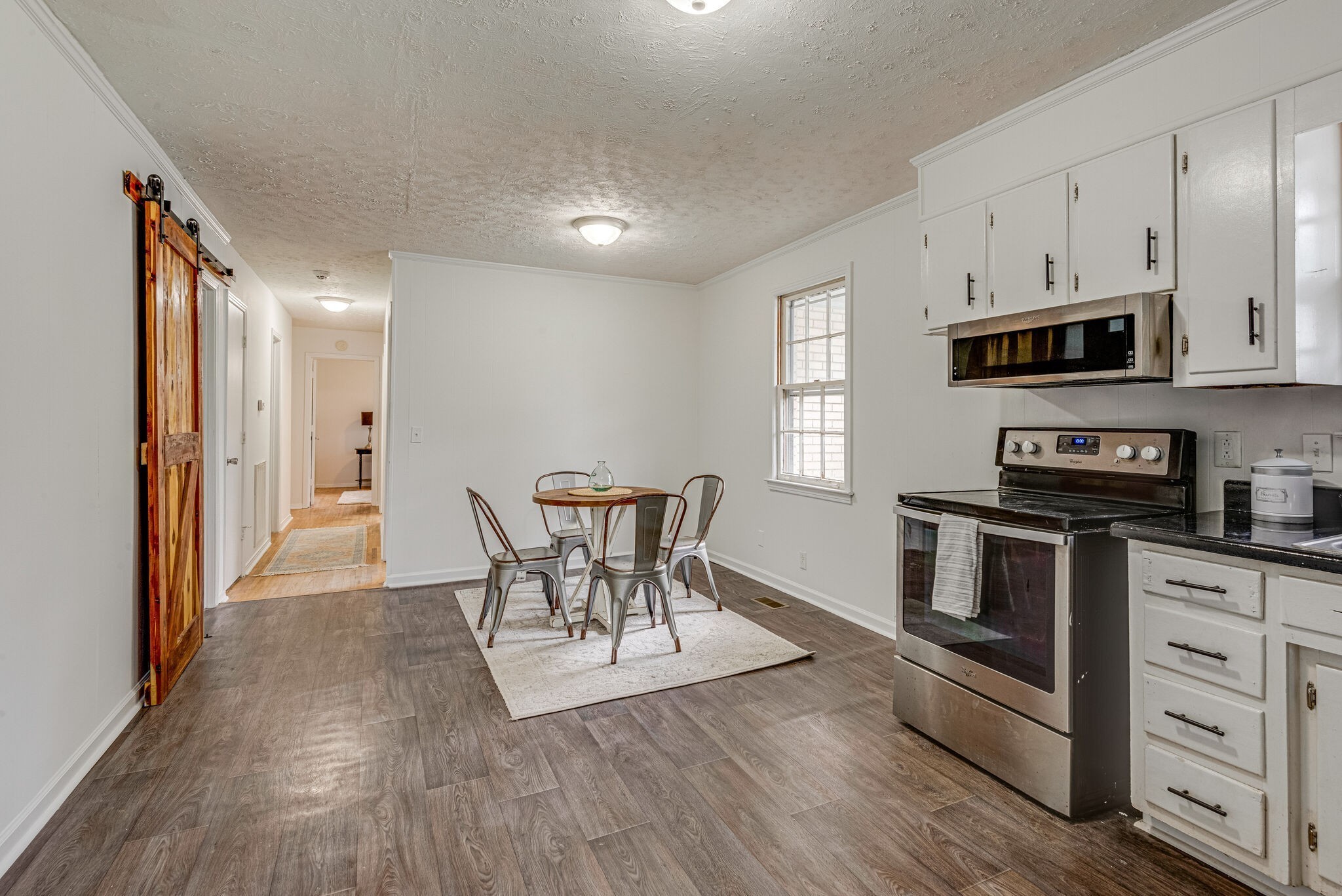 108 Chestnut Drive Dickson, TN 37055 - Photo 8 of 25 a kitchen with stainless steel appliances kitchen island granite countertop a stove a sink and a refrigerator