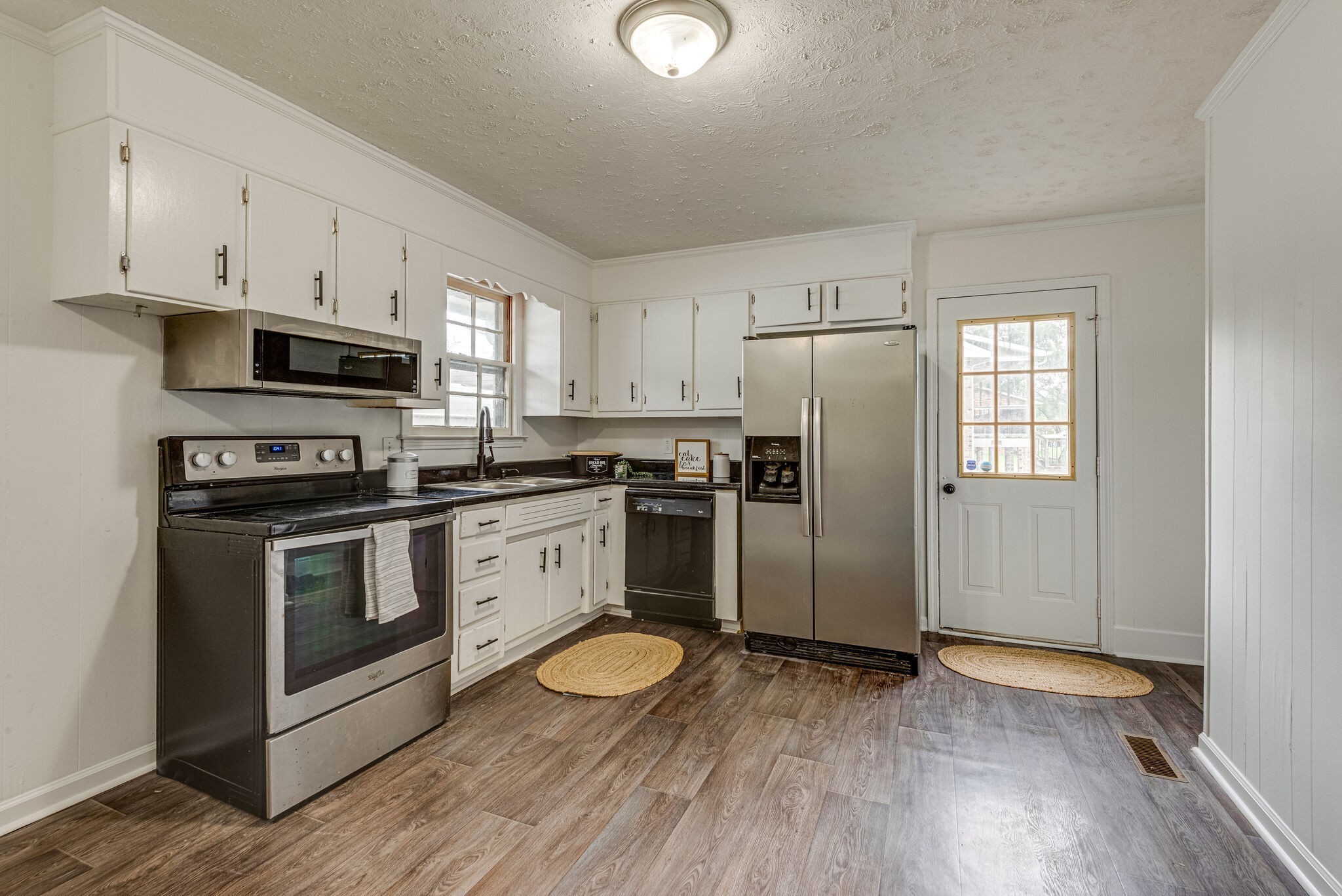 108 Chestnut Drive Dickson, TN 37055 - Photo 10 of 25 a kitchen with granite countertop a refrigerator a stove top oven and wooden floor