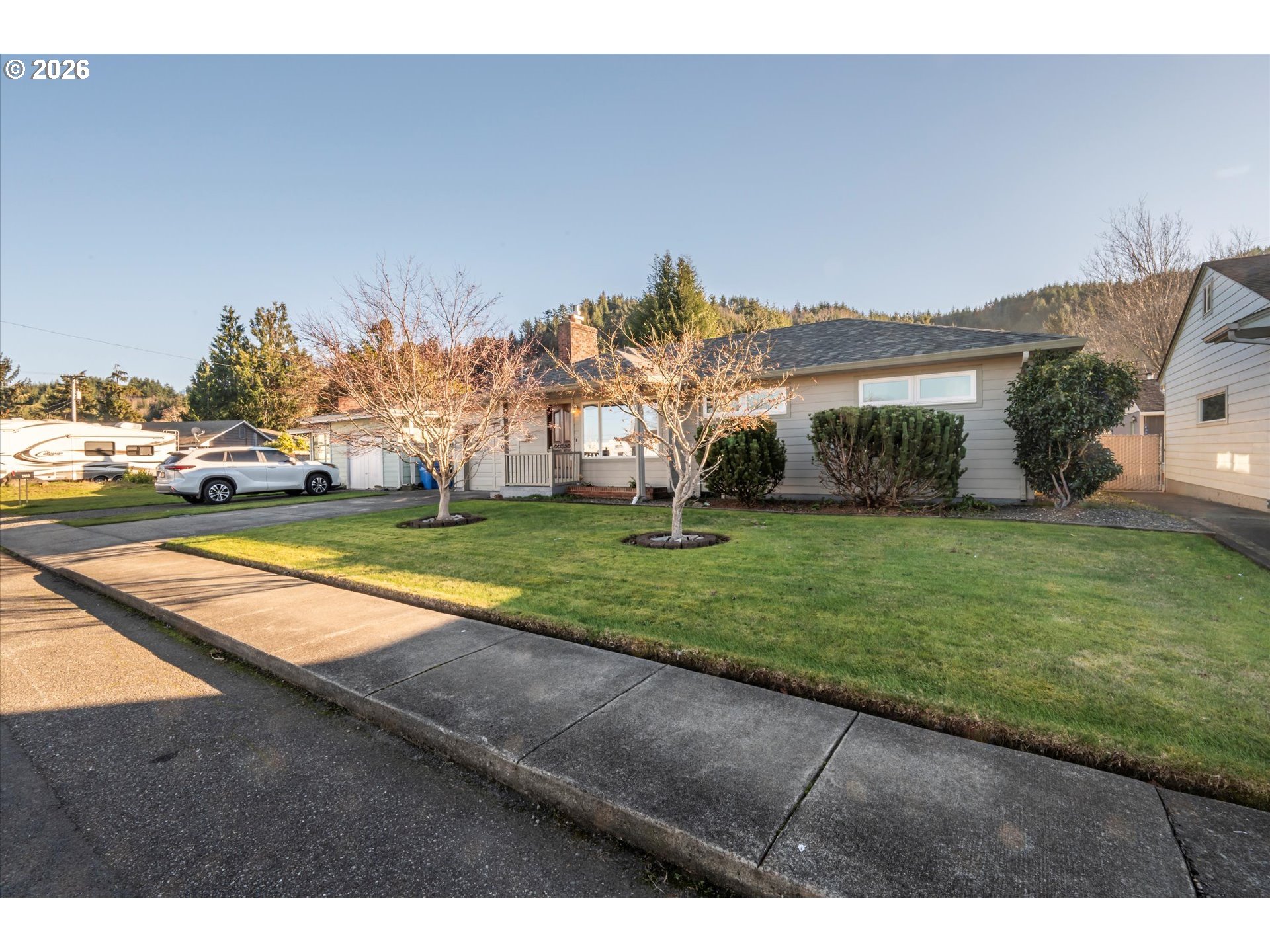 2480 Gardens Avenue Reedsport, OR 97467 - Photo 1 of 22 a view of a house with a big yard and palm trees