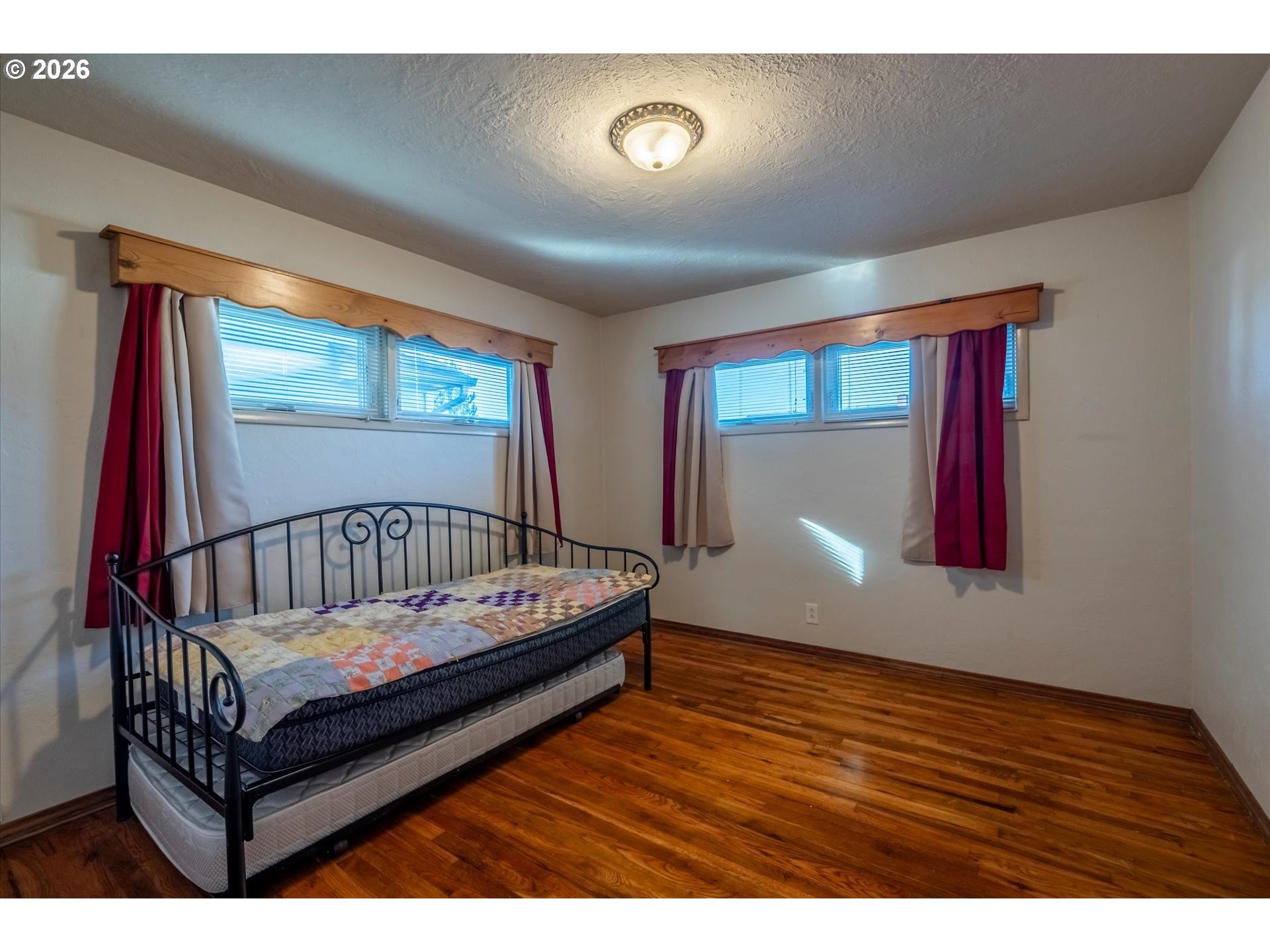 2480 Gardens Avenue Reedsport, OR 97467 - Photo 15 of 22 a view of a hallway with wooden floor and windows