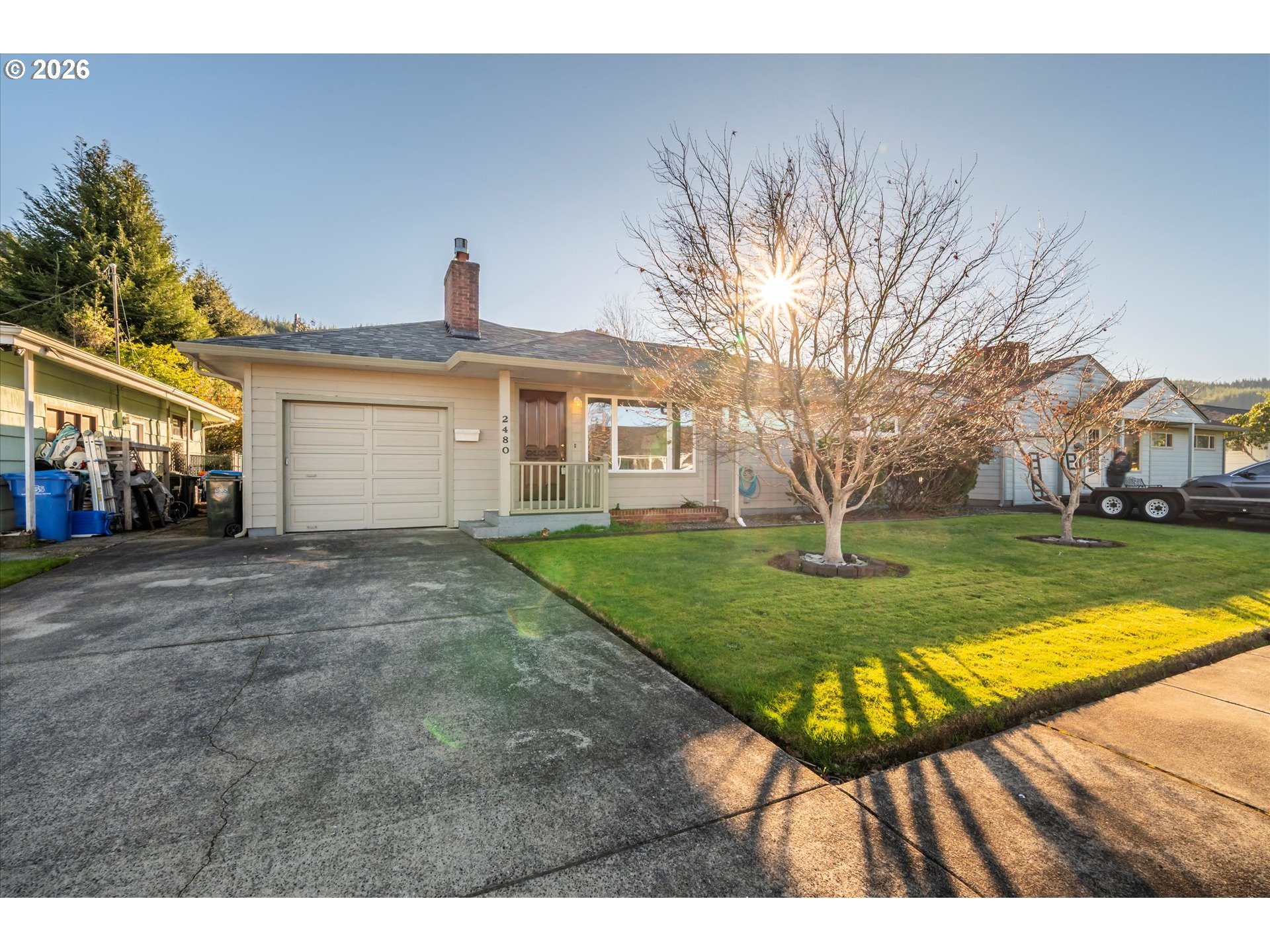 2480 Gardens Avenue Reedsport, OR 97467 - Photo 2 of 22 a view of an house with backyard and trees