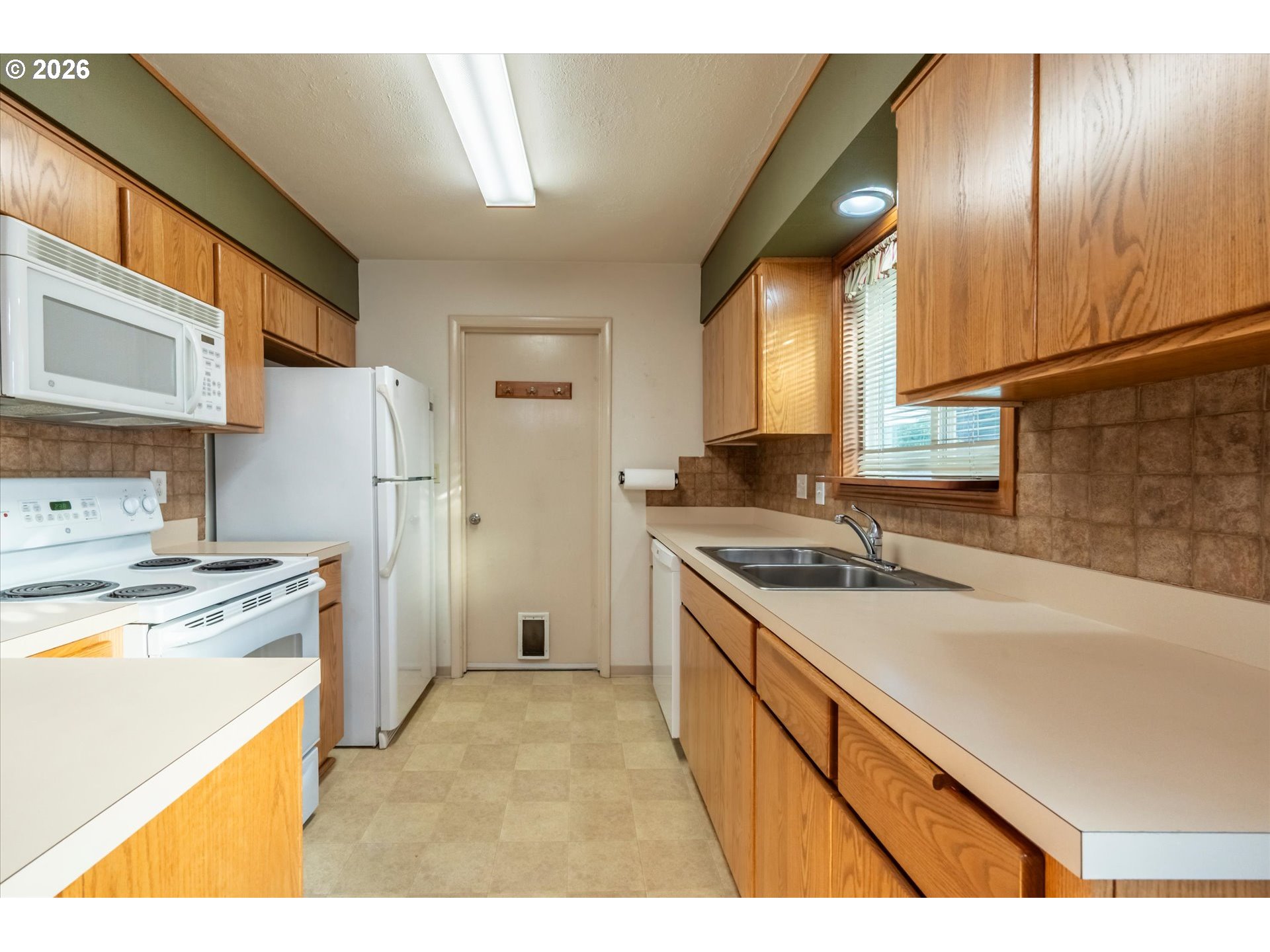 2480 Gardens Avenue Reedsport, OR 97467 - Photo 8 of 22 a kitchen with a stove a sink and a refrigerator