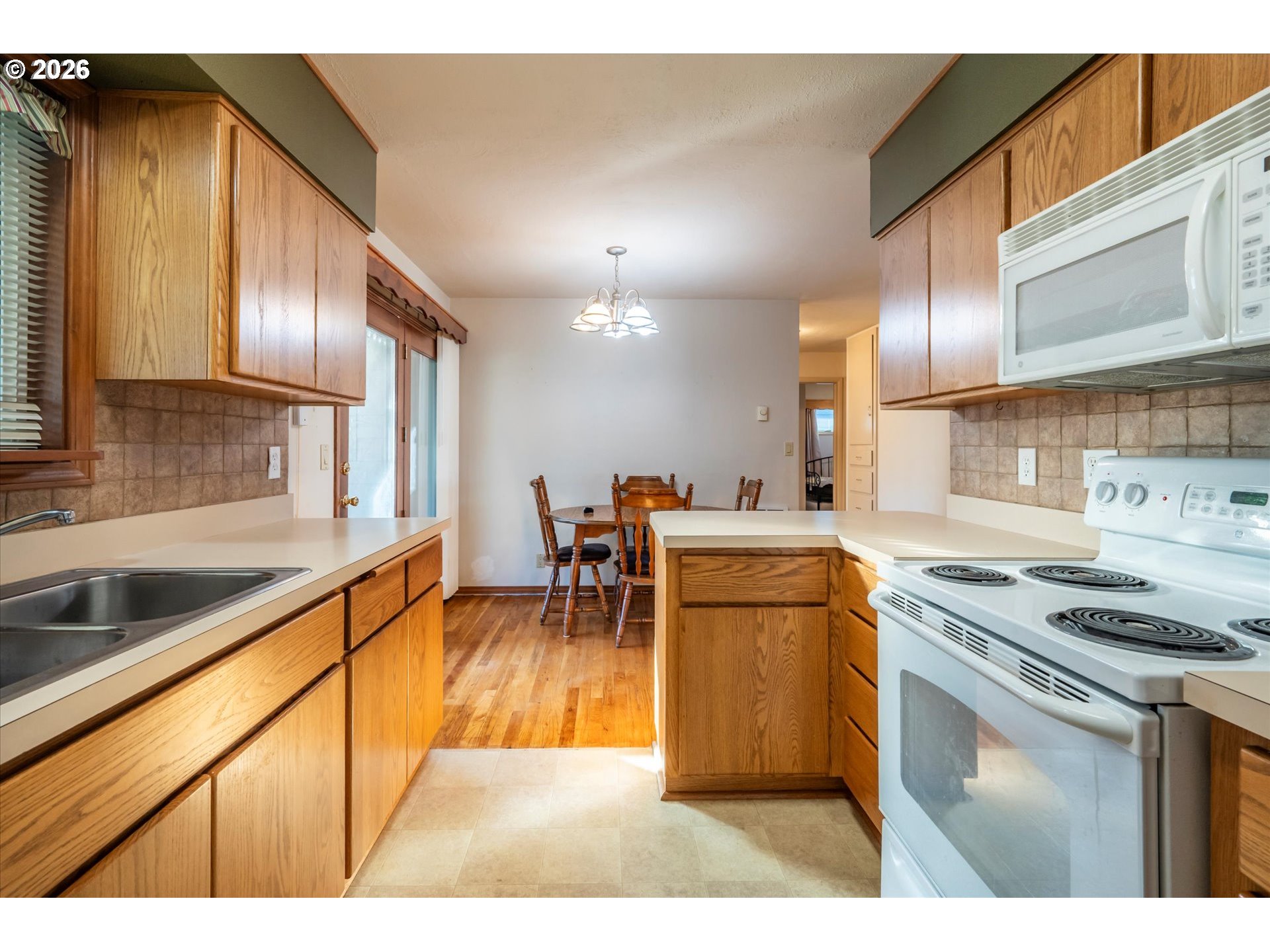 2480 Gardens Avenue Reedsport, OR 97467 - Photo 9 of 22 a kitchen with kitchen island granite countertop a sink cabinets and stainless steel appliances