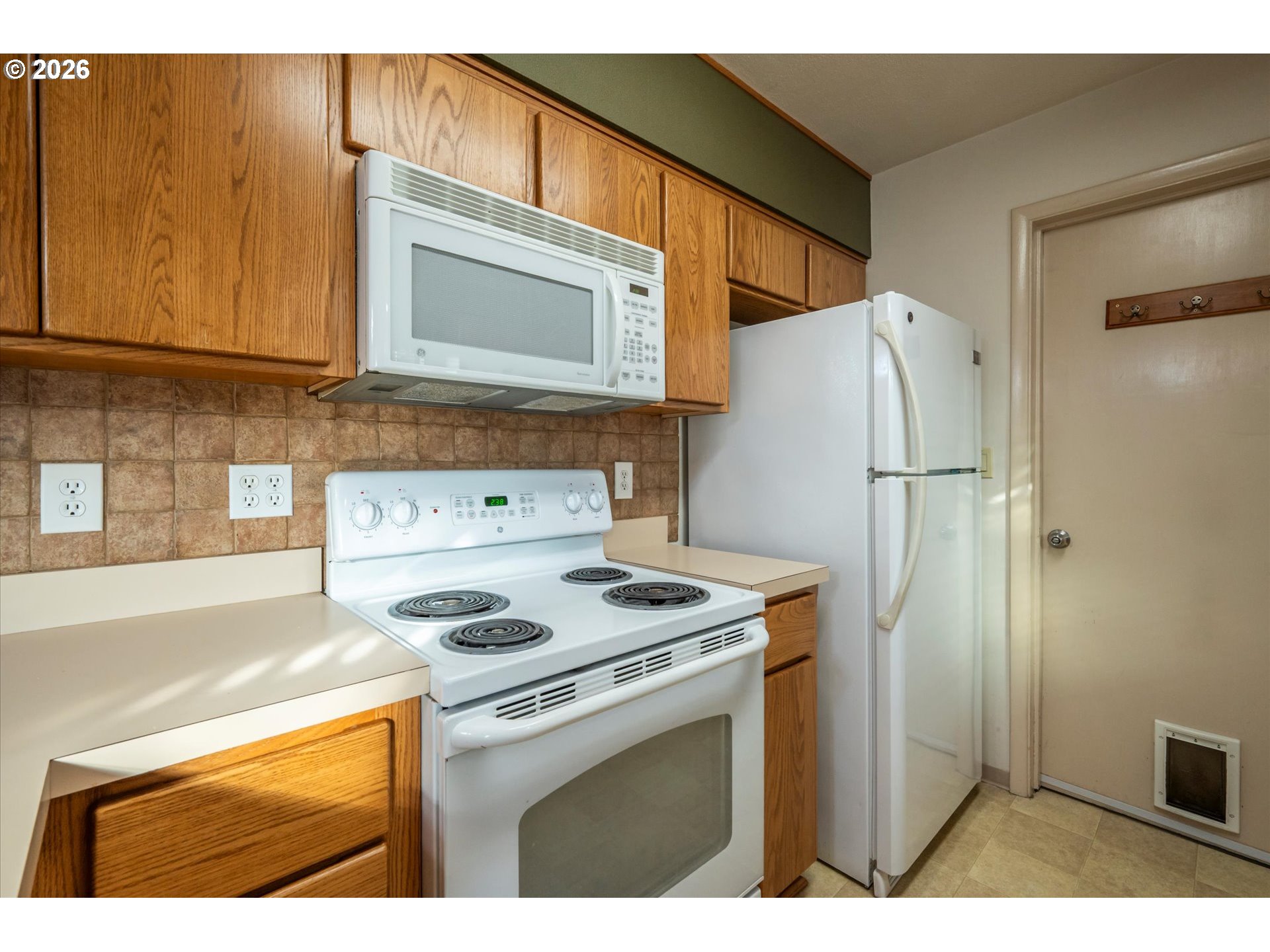 2480 Gardens Avenue Reedsport, OR 97467 - Photo 10 of 22 a kitchen with stainless steel appliances granite countertop a refrigerator a stove and a sink