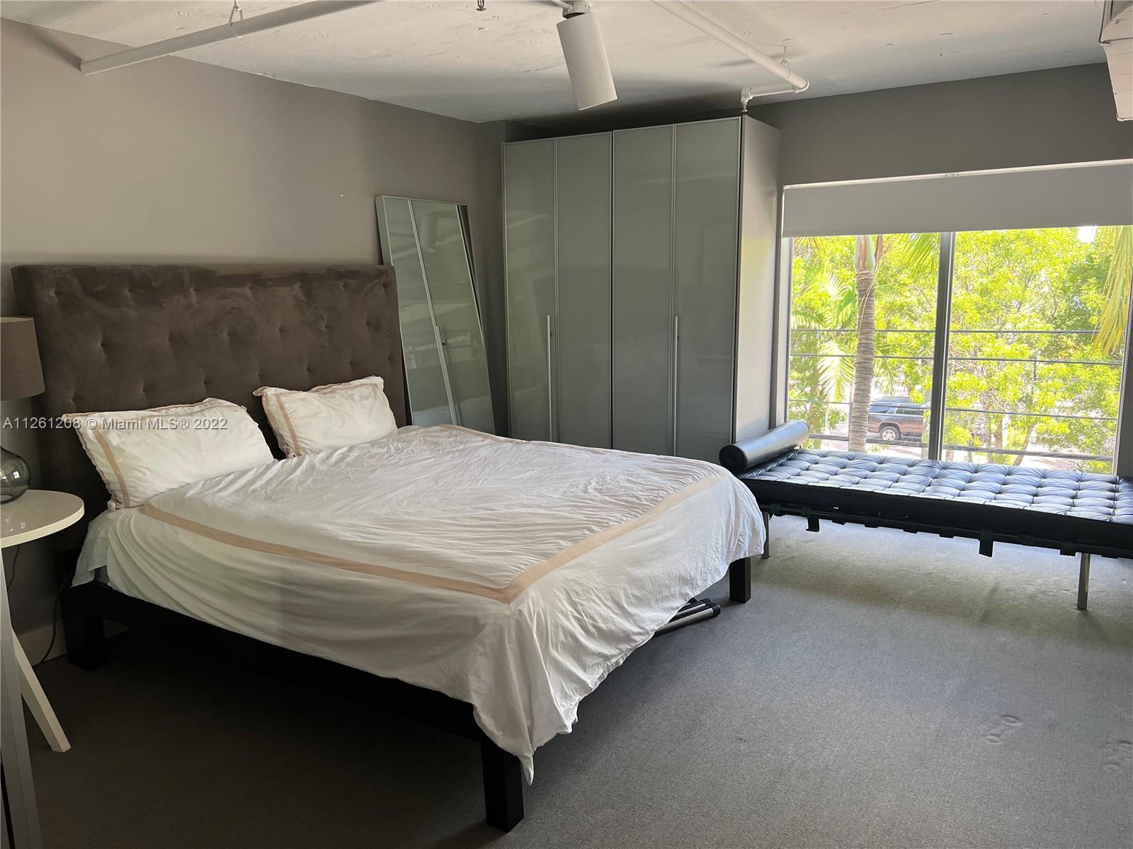 900 4th Street, Unit 2 Miami Beach, FL 33139 - Photo 12 of 15 a bedroom with a bed and window