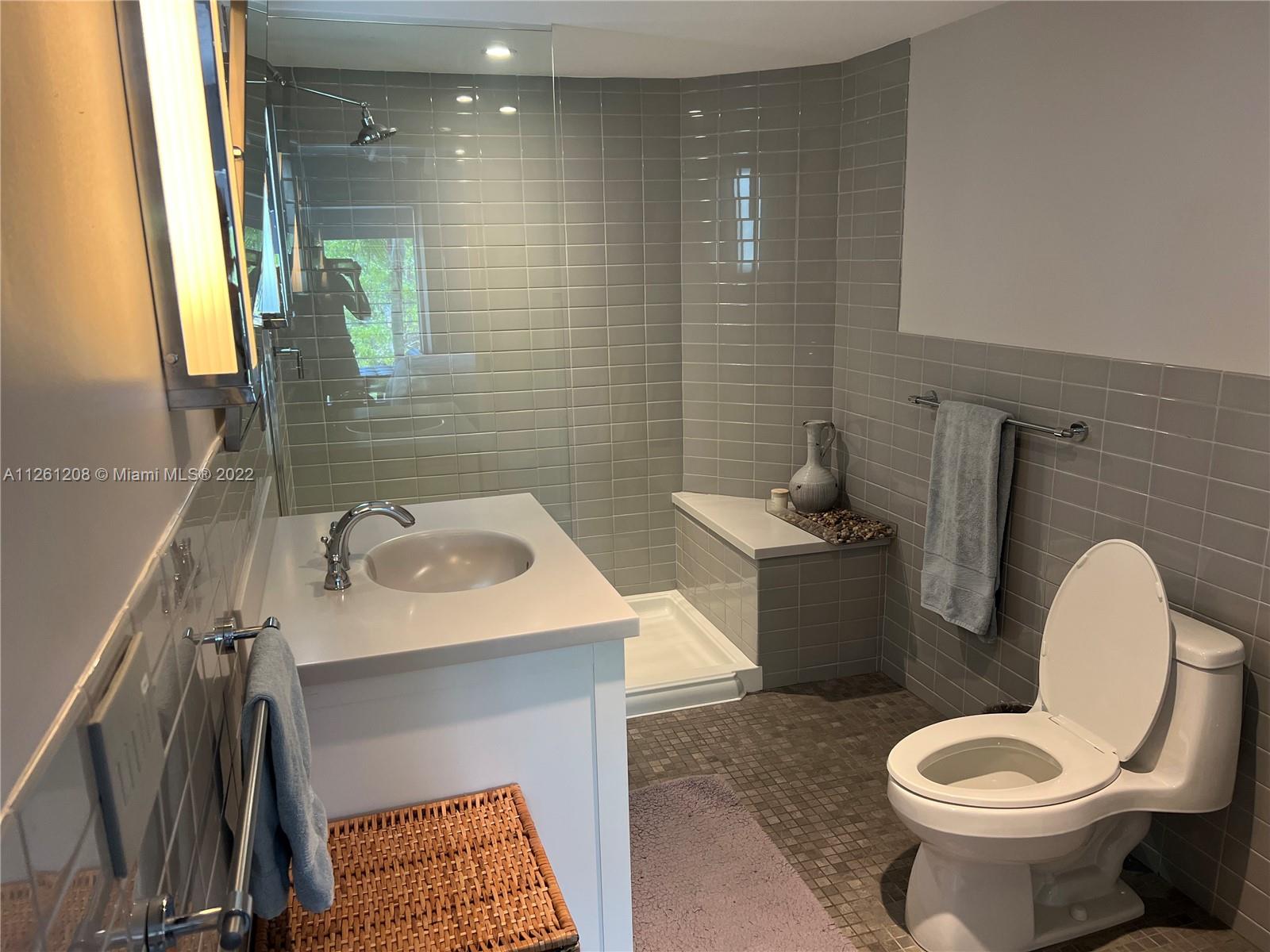 900 4th Street, Unit 2 Miami Beach, FL 33139 - Photo 13 of 15 a bathroom with a toilet sink and mirror