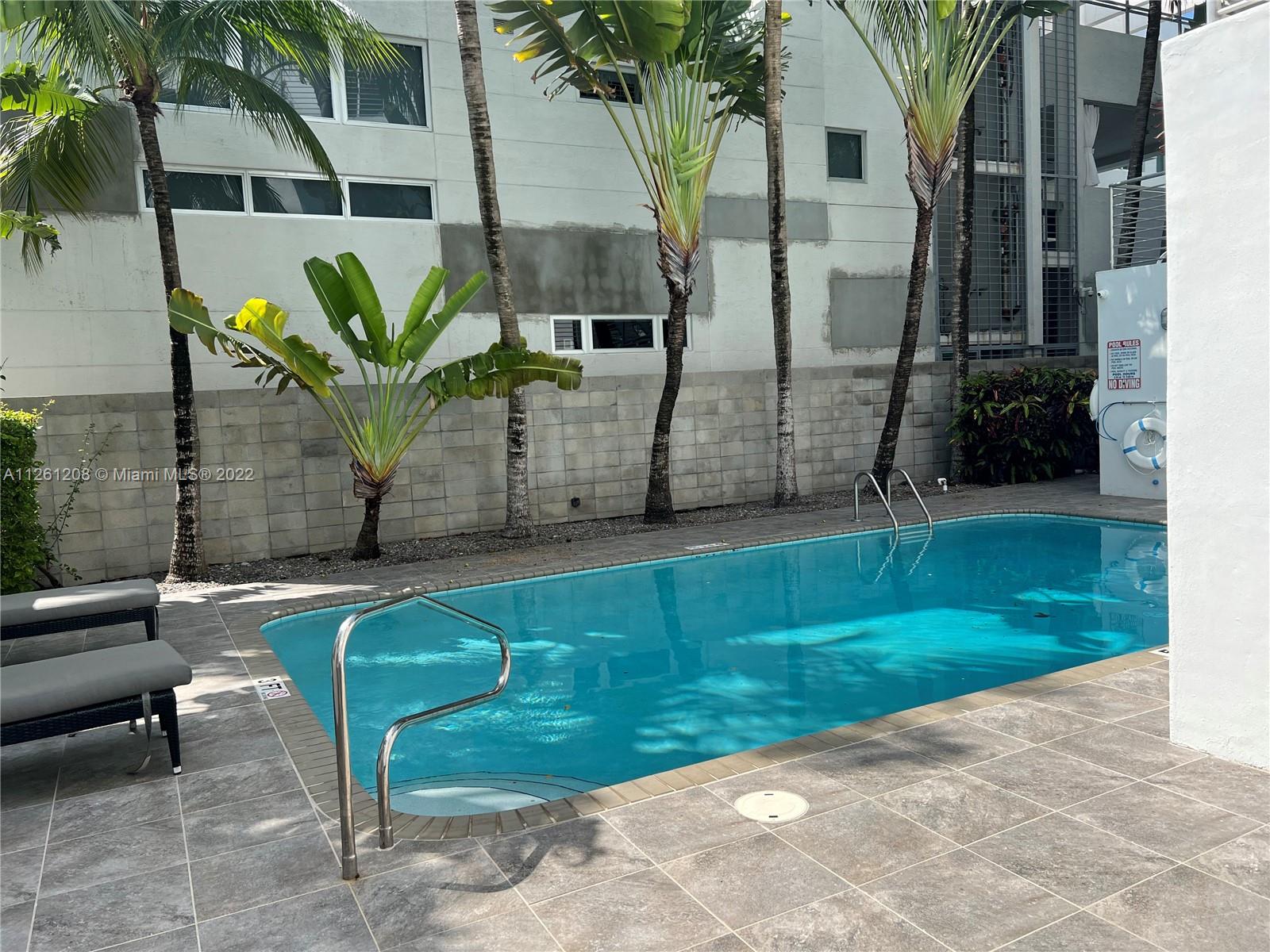 900 4th Street, Unit 2 Miami Beach, FL 33139 - Photo 14 of 15 a view of backyard with outdoor seating and plants