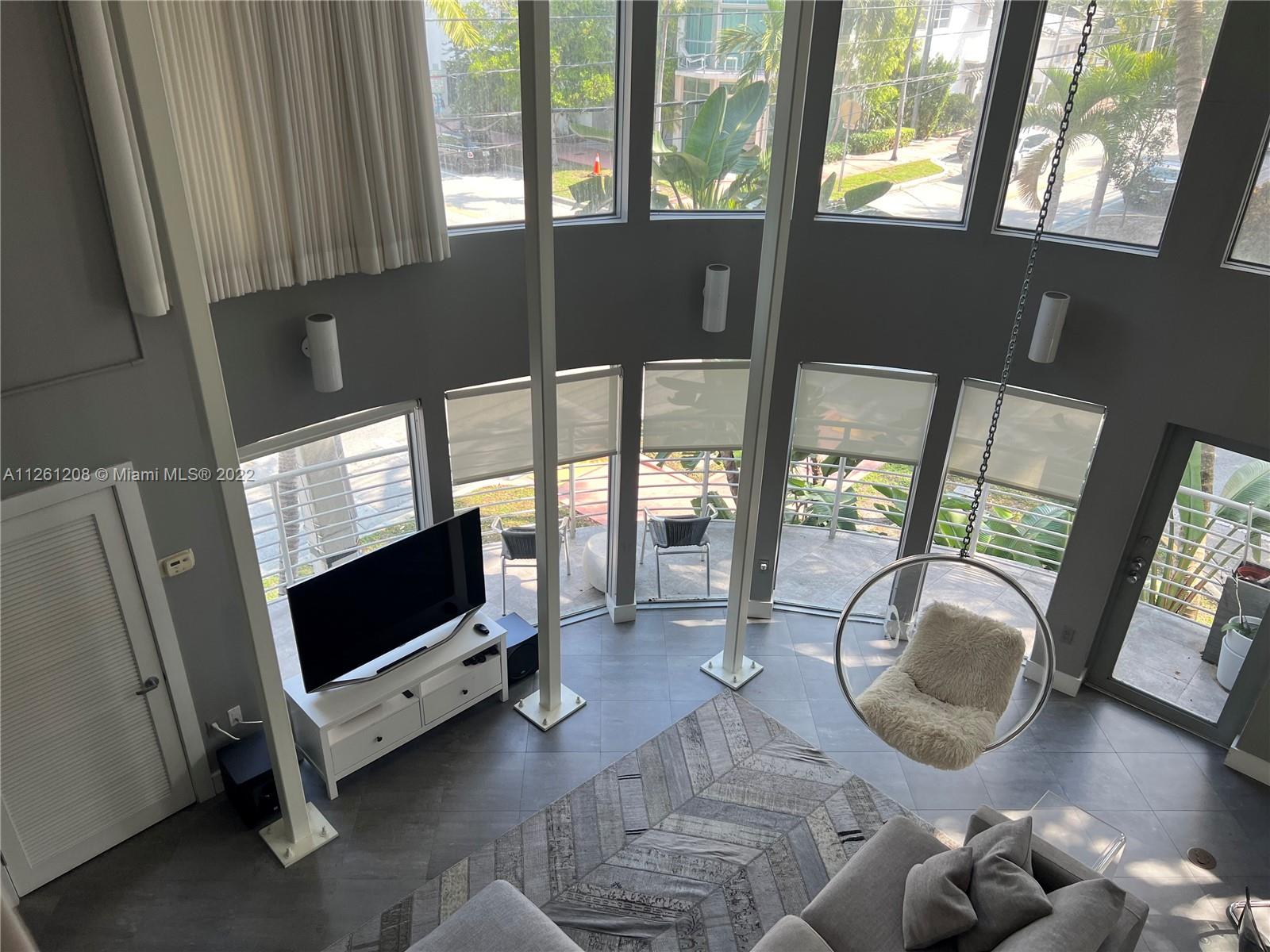 900 4th Street, Unit 2 Miami Beach, FL 33139 - Photo 2 of 15 a living room with furniture and a flat screen tv